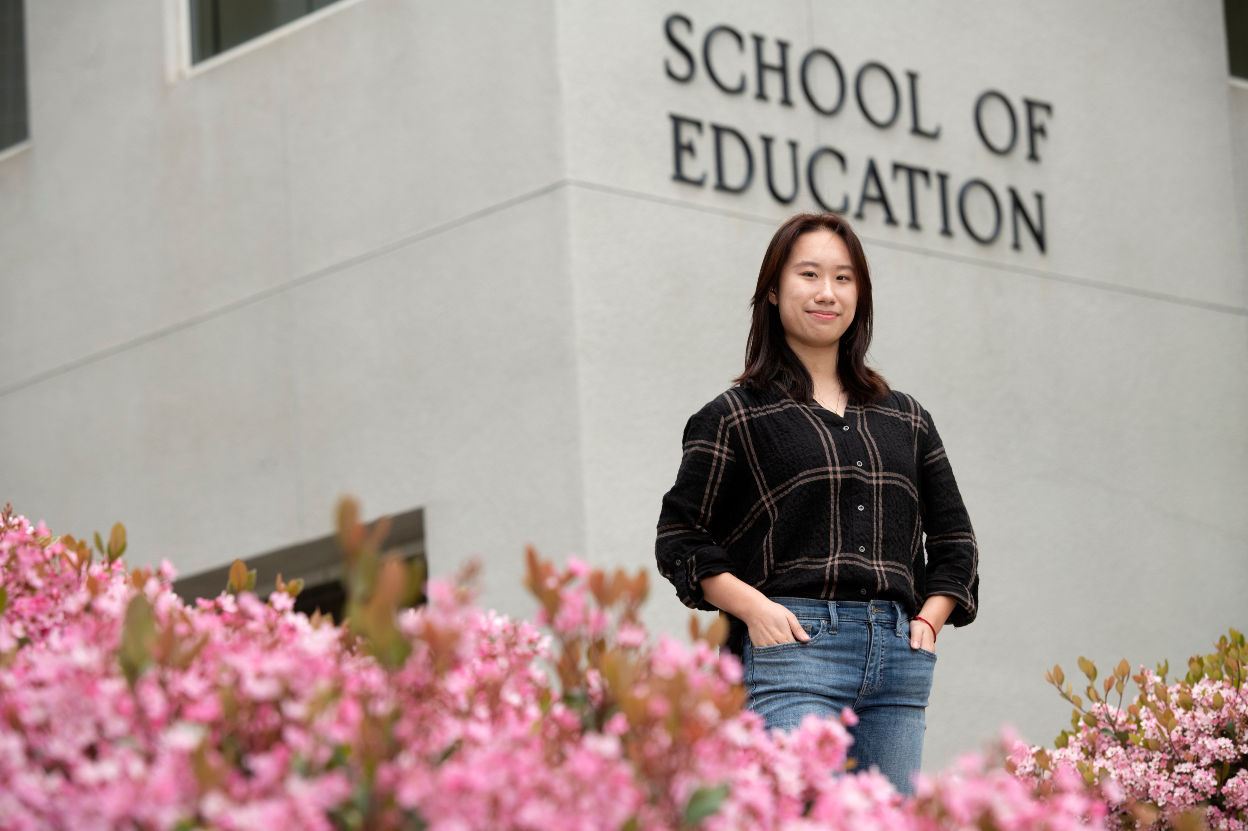 Jessica Cai in front of the School of Education