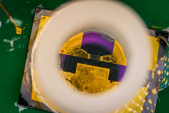 Closer view of biosensor with gold-colored metallic transistor in the bottom of a rubber ring.
