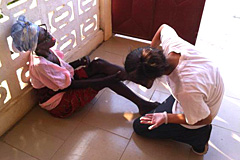Arienne Malekmadani treats a Ghanian patient's wound.