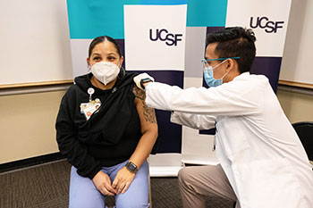 UCSF employee Reina Lopez being vaccinated against COVID-19
