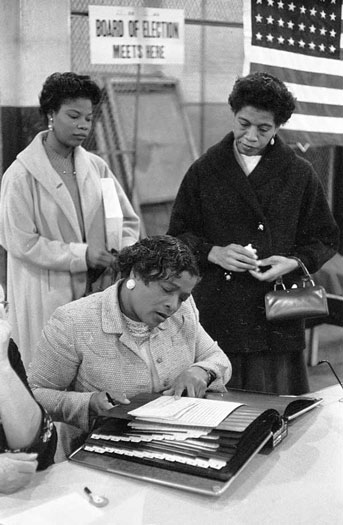 Three black women at a polling place in the 1960s