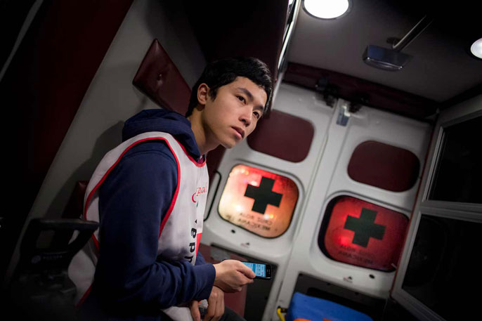 Student sits in an ambulance