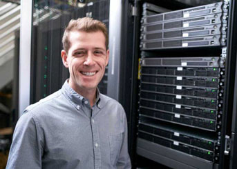 Michael Keiser in front of stack of servers