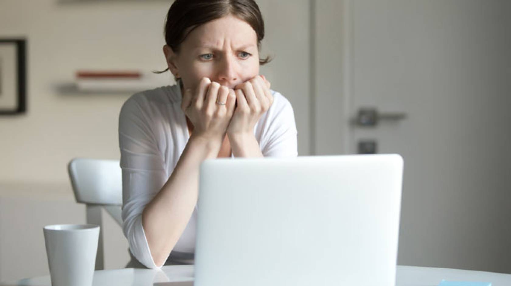 Woman anxiously looking at computer
