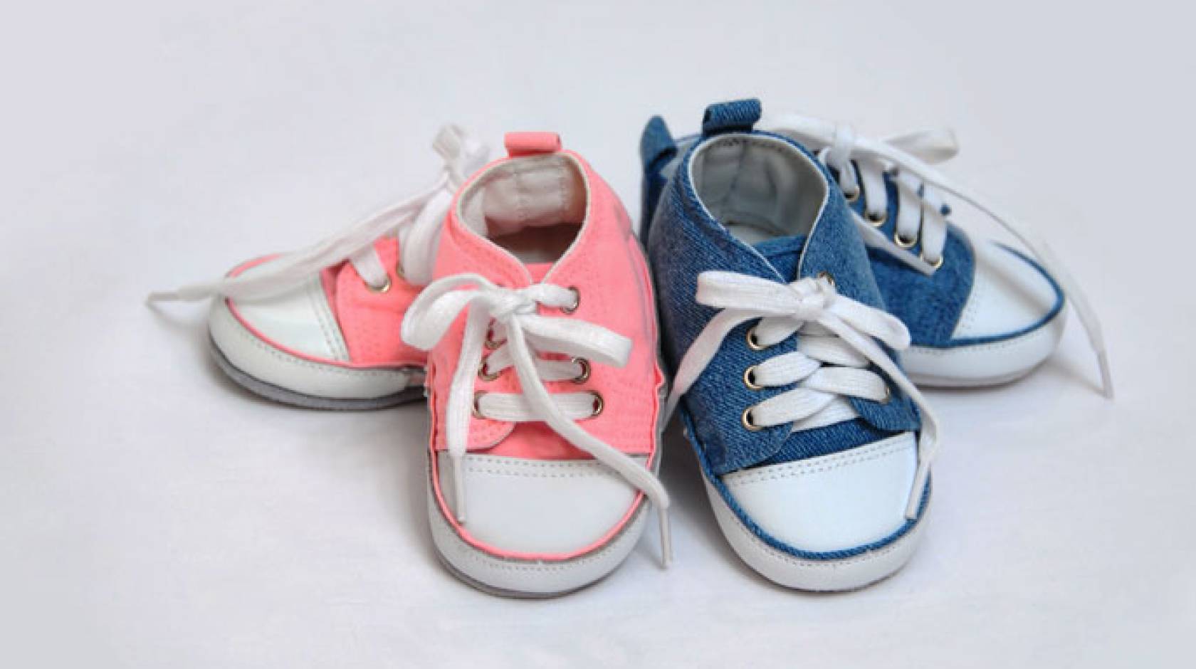 Baby girl and baby boy shoes next to each other
