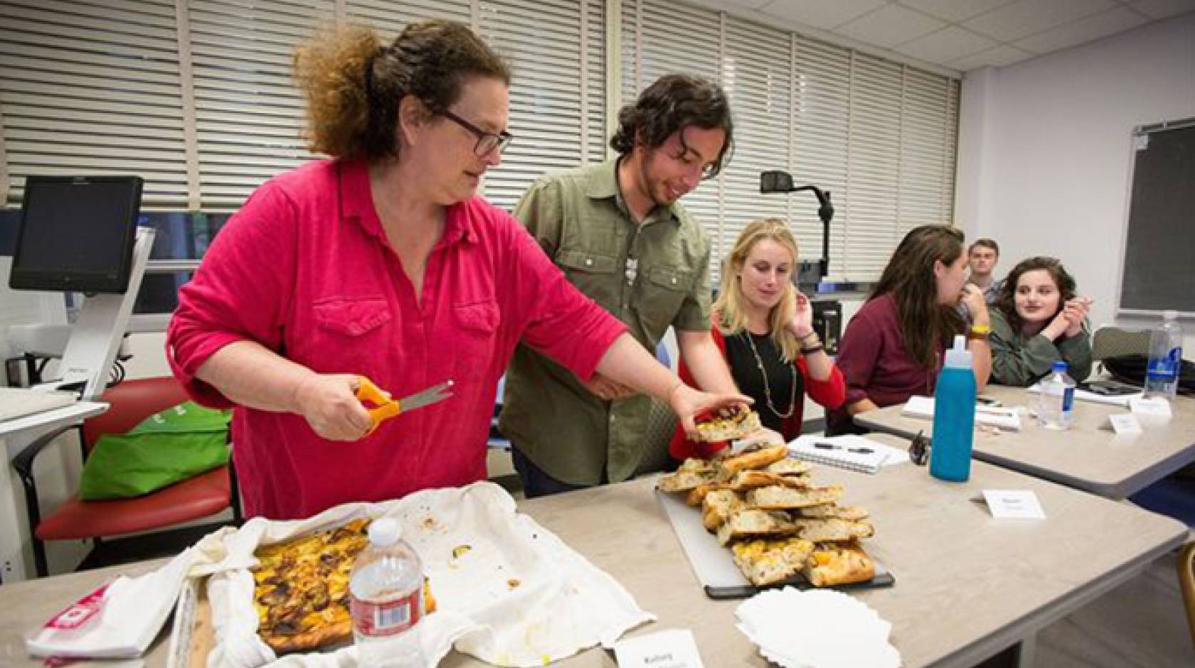 Evan Kleiman's students take a break from serious discussions about food issues to enjoy a focaccia pizza she made. Sharing food and recipes is an essential part of the course.