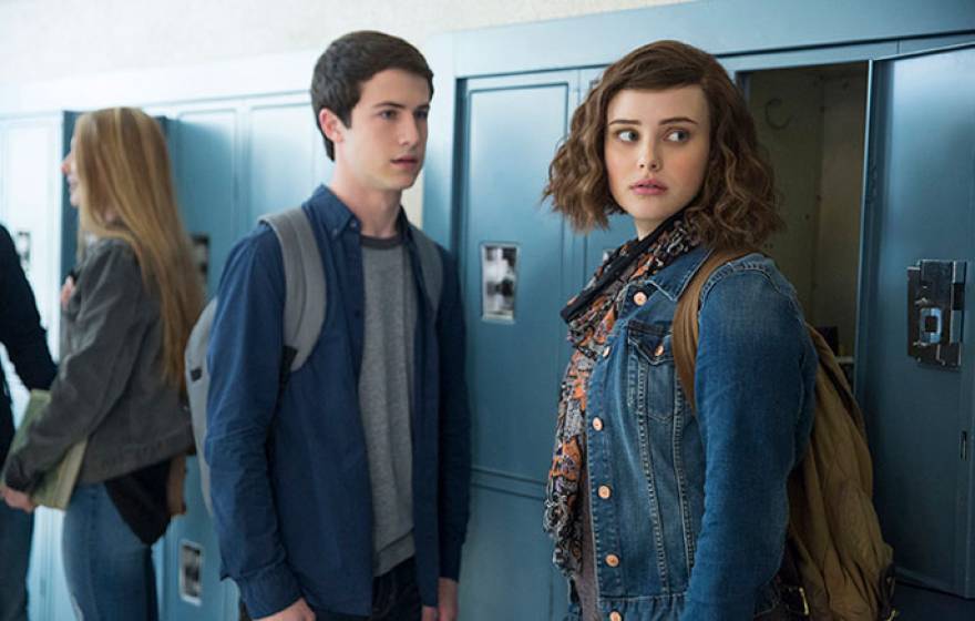 Two teens stand in front of locker in 13 Reasons Why