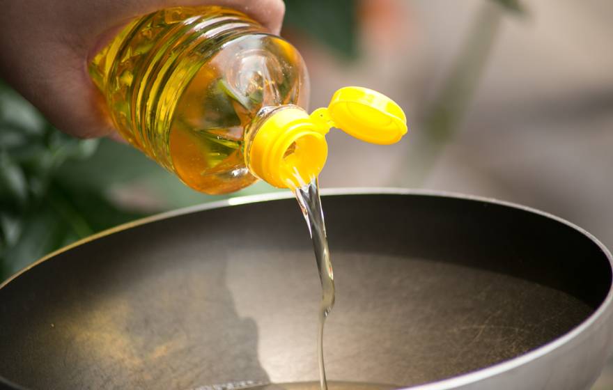 Soybean oil being poured into a hot skillet