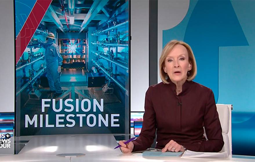 Anchor Judy Woodruff at the desk, with a graphic about fusion ignition on the side