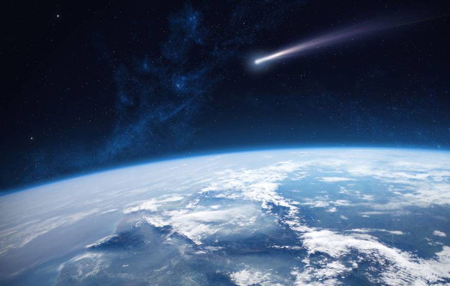 Photorealistic illustration from a spacecraft's-eye-view looking over the curve of the earth with a comet streaking through the middle of the image