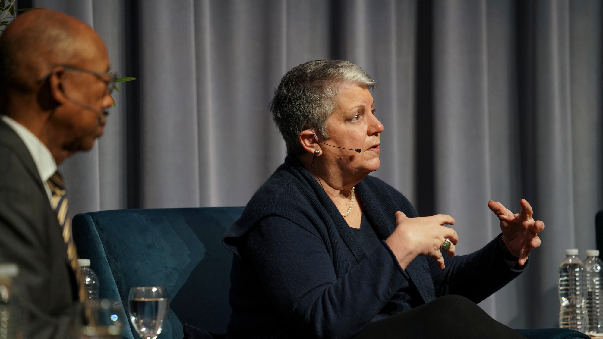 Michael V. Drake next to Janet Napolitano at a UC Davis panel, Napolitano speaking