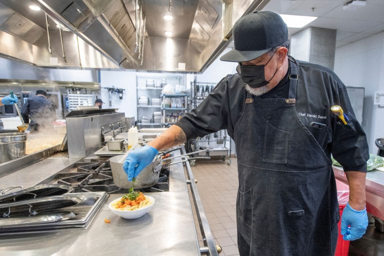 Anteatery chef Harold Duenas puts the finishing touches on a pasta dish.