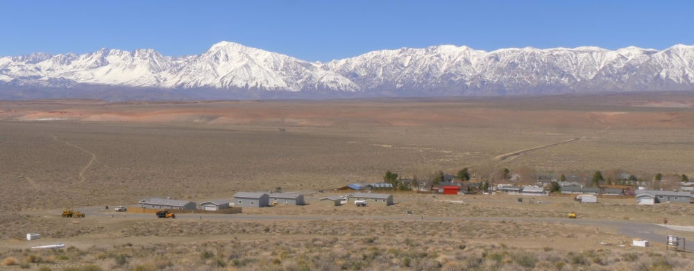 Sierra snowpack with brown fields in front of it