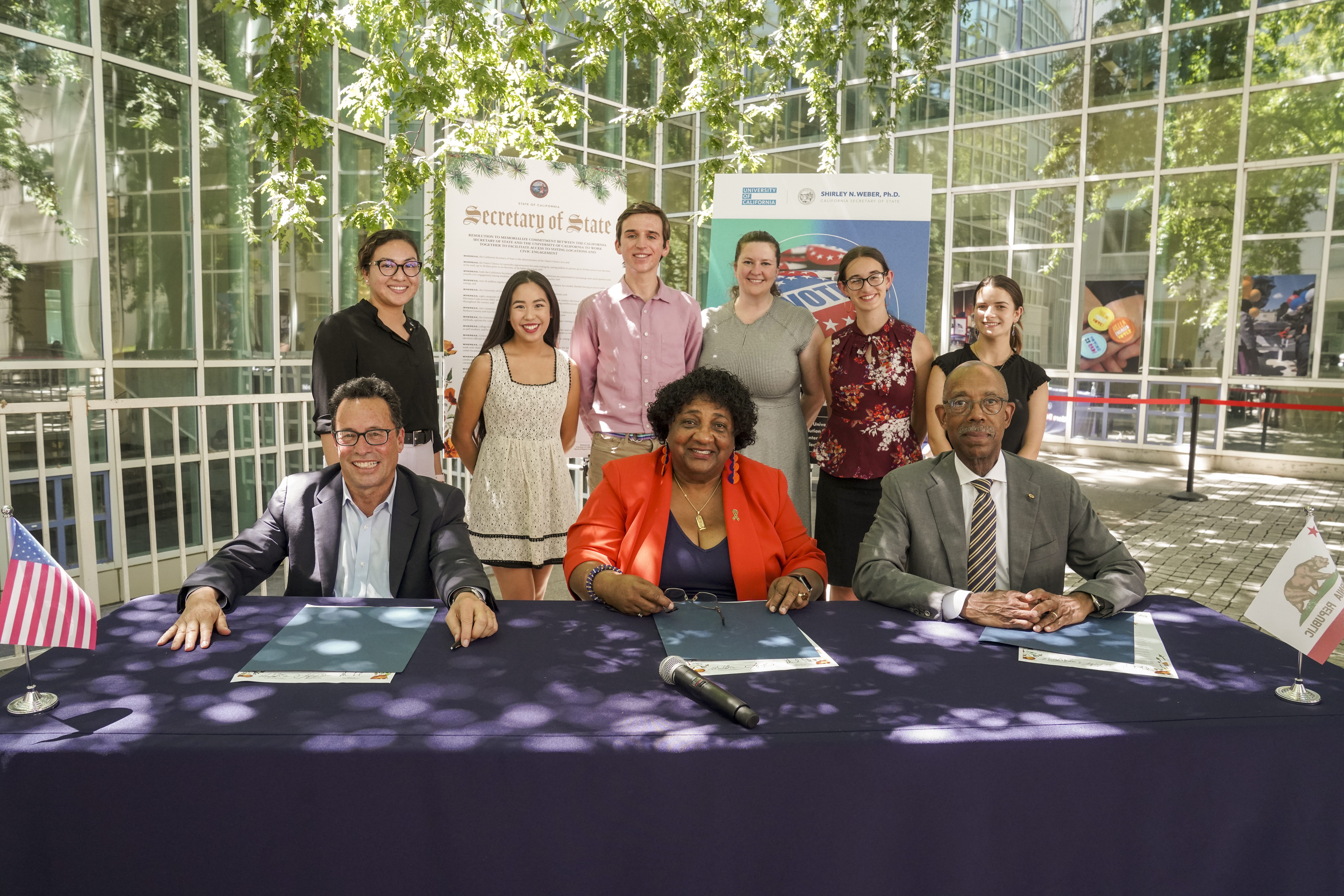 UC Board of Regents Vice Chair Leib, California Secretary of State Weber, and UC President Drake sign voting resolution joined by students at UC Davis.