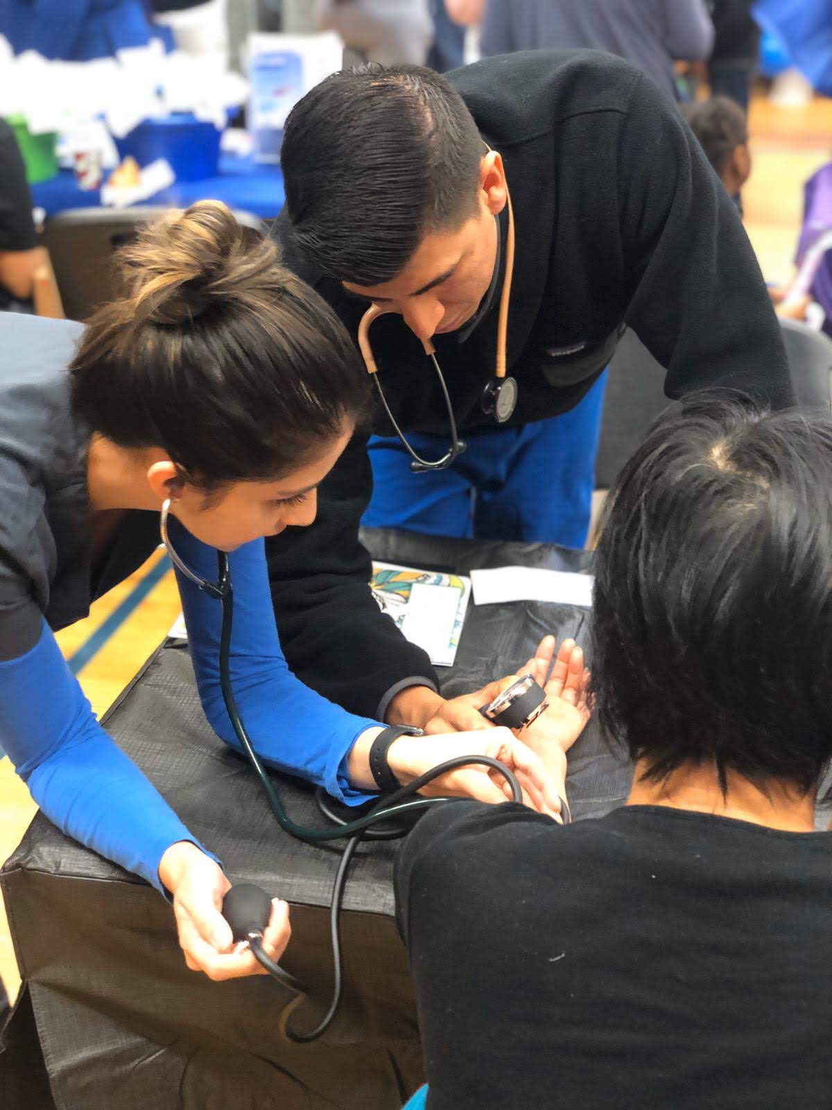 Rosa Mora and her colleague tend to a patient with a broken leg