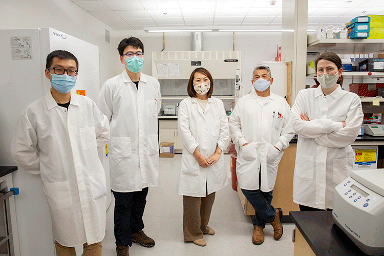 Members of Naar Lab standing together in masks