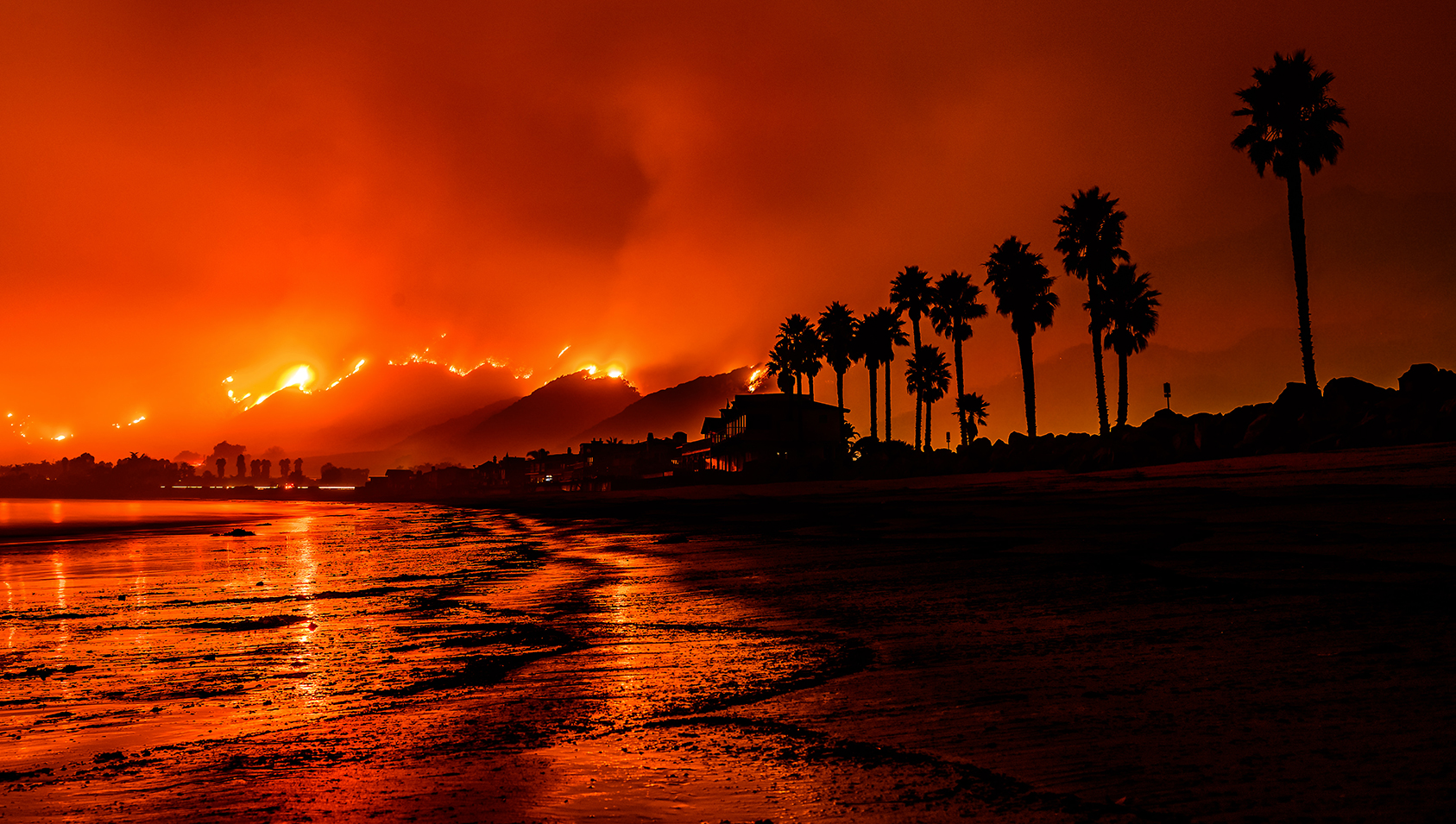 View of the Thomas Fire coloring the sky read over the beach in Santa Barbara