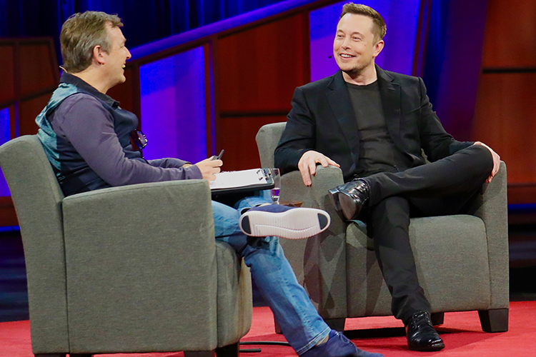Elon Musk at a TED talk, seated