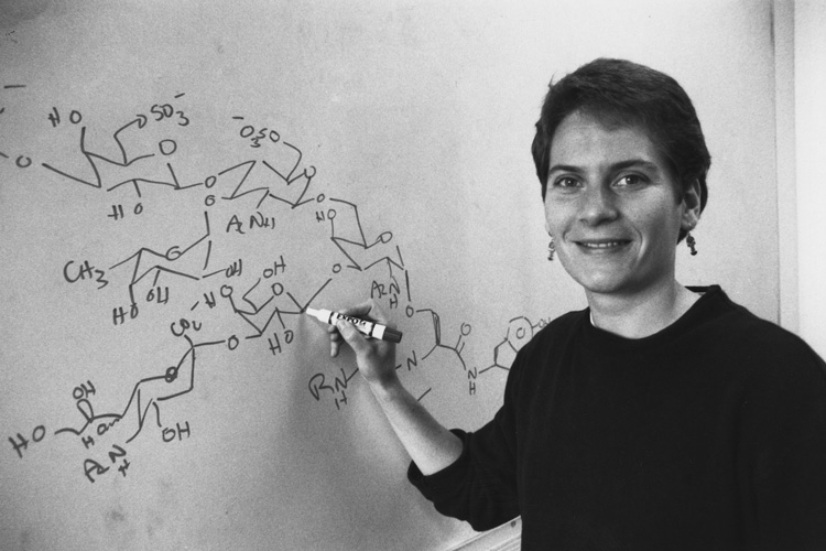Young Carolyn Bertozzi at a chalkboard