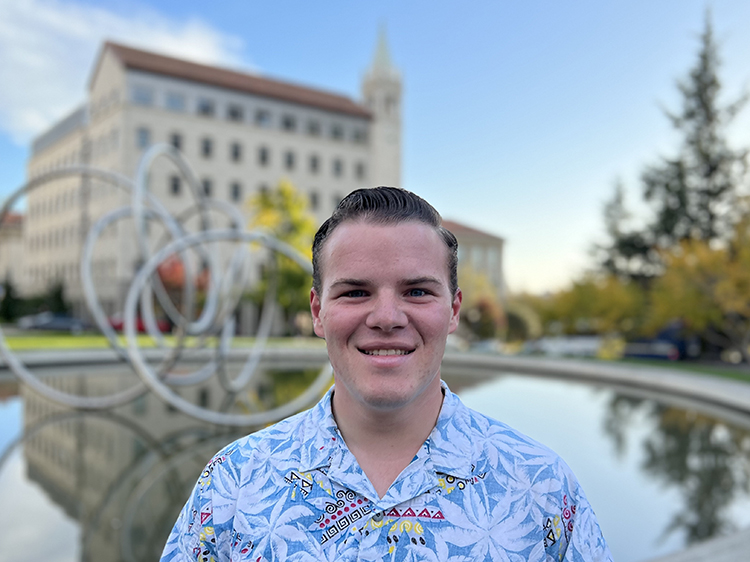 Matt Rowe smiles, UC Berkeley campus behind him