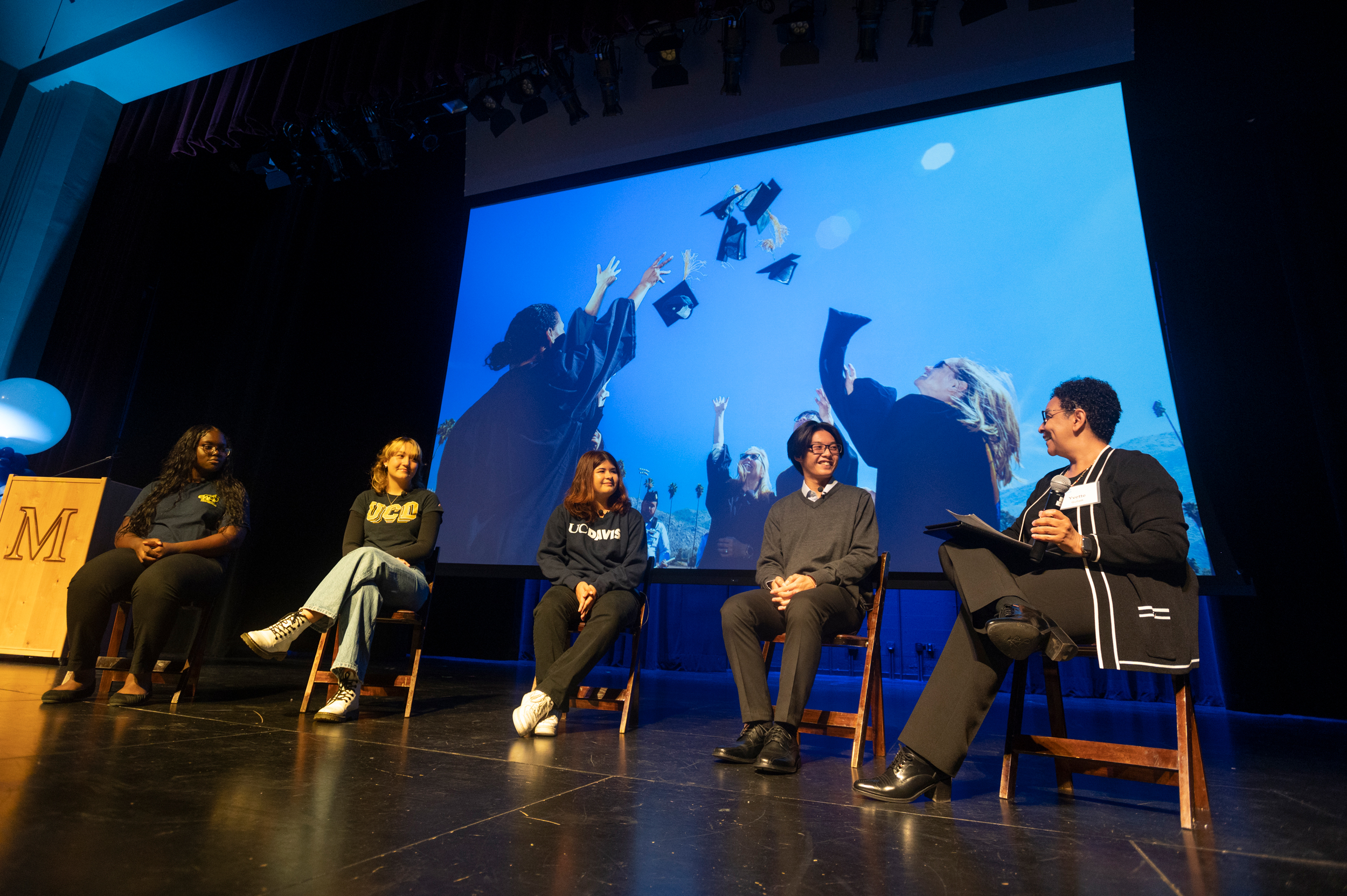 Yvette Gullatt on stage at McClatchy High with several students