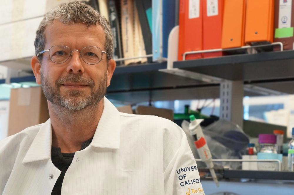 Thomas Weimbs in the lab, wearing a lab coat