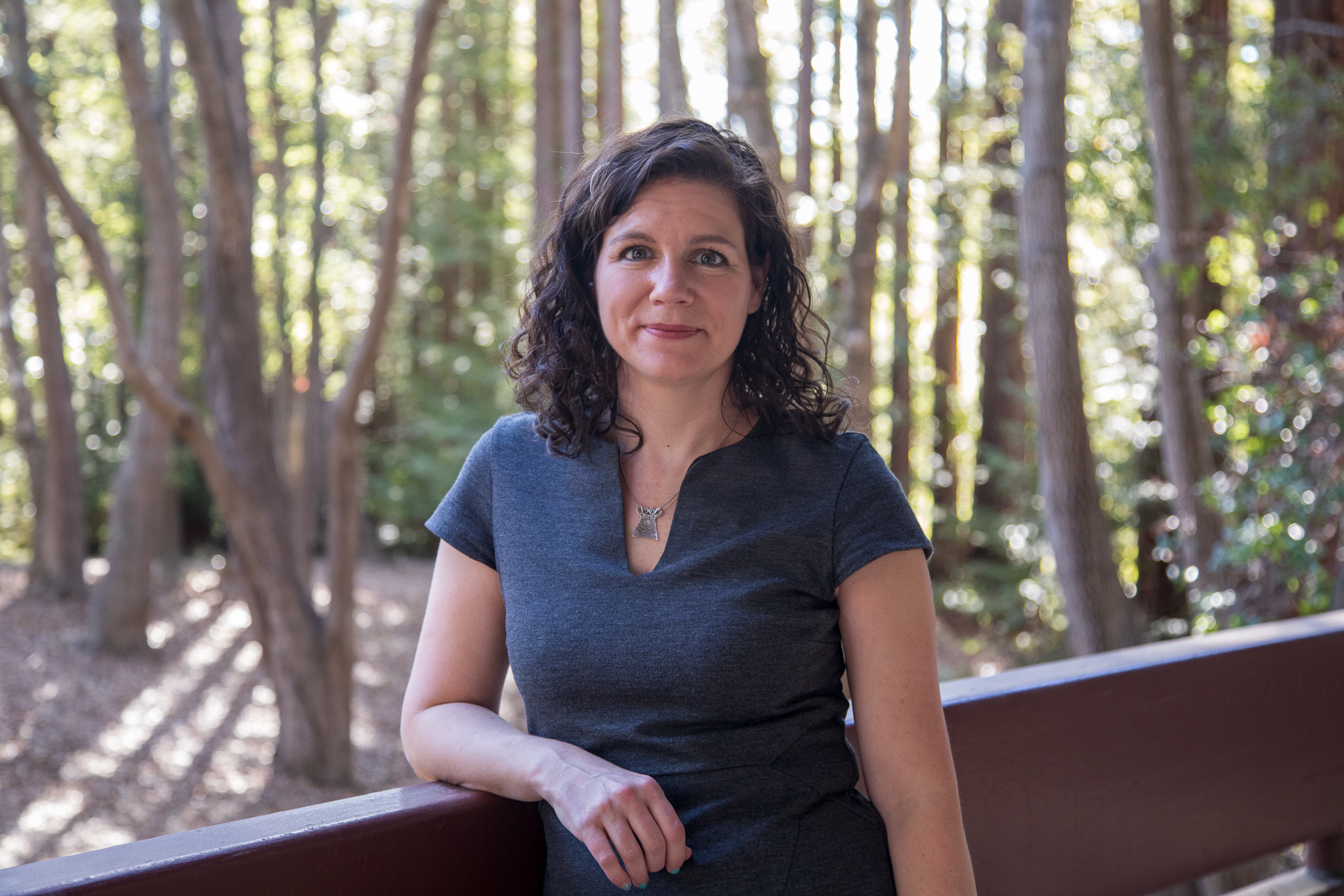 Karen Miga in front of trees on UC Santa Cruz campus