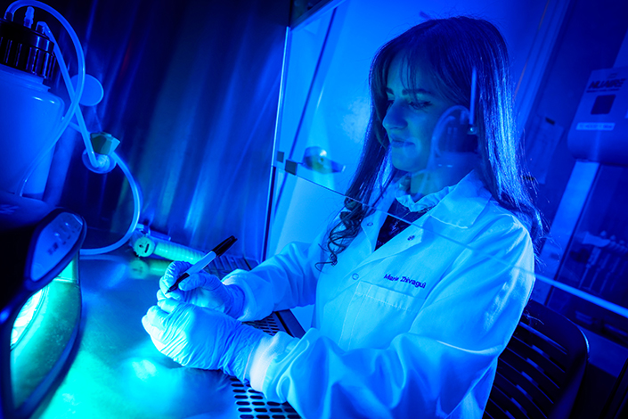 Woman in lab in blue light