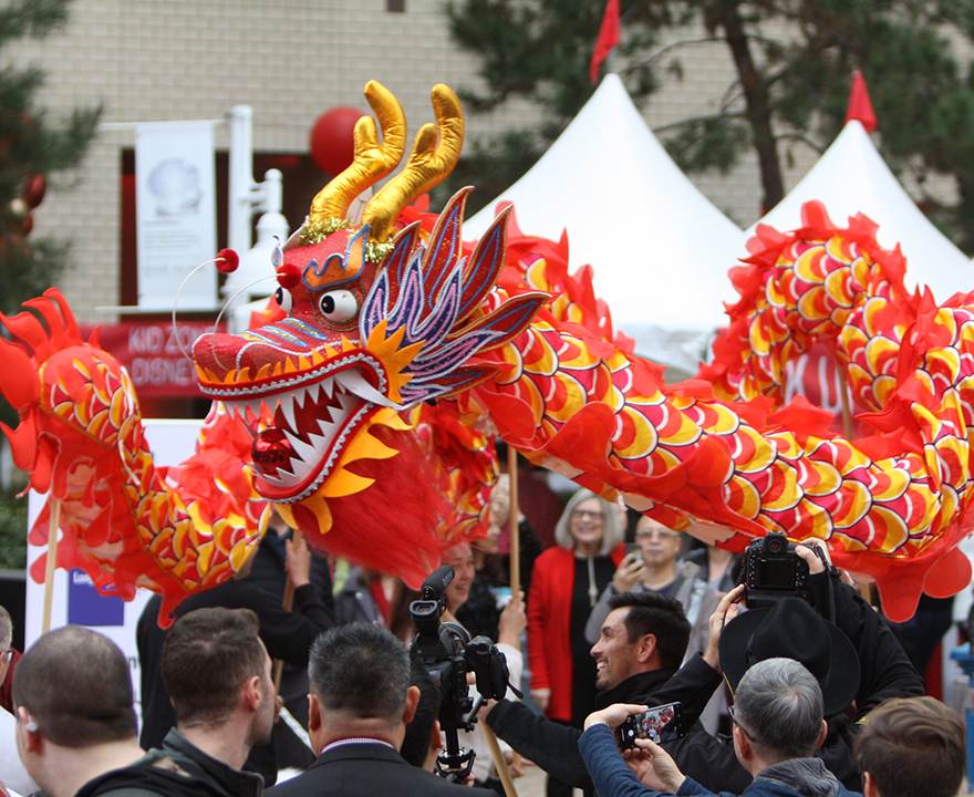 Dragon on stilts at a Lunar New Year parade