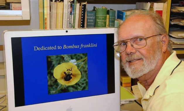 Franklin’s bumblebee on a computer screen next to the late Robbin Thorpe, looking at the camera