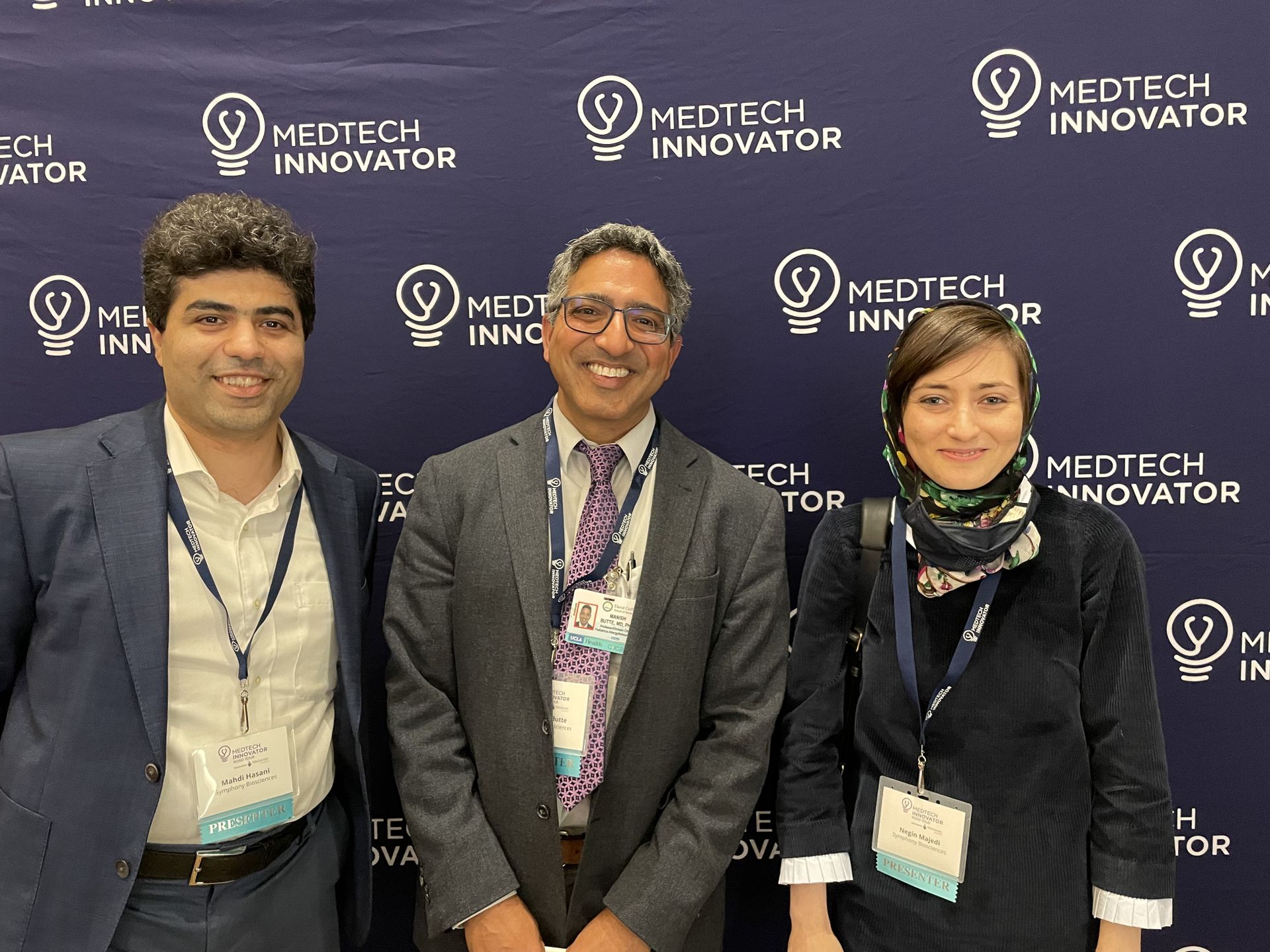 Three people standing together: From left: UCLA project scientist and Symphony chief scientific officer Mahdi Hasani, UCLA professor Manish Butte, and UCLA alumna and Symphony CEO Negin Majedi