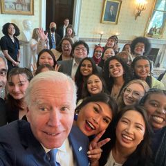 President Joe Biden snaps a selfie with Meera Varma and others attending the White House Mental Health Youth Action Forum in May 2022