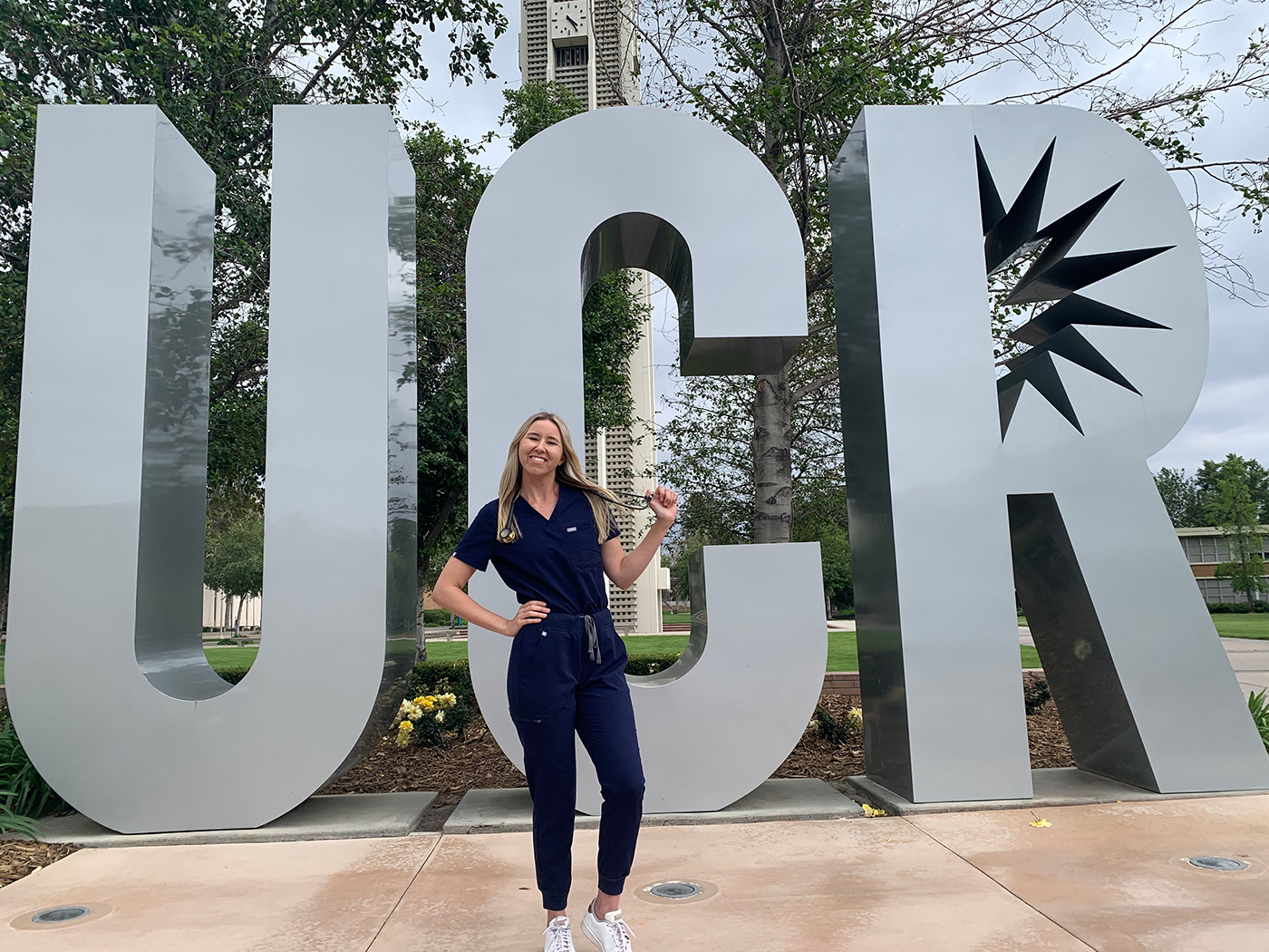 Skylar Rains in front of the UCR sign