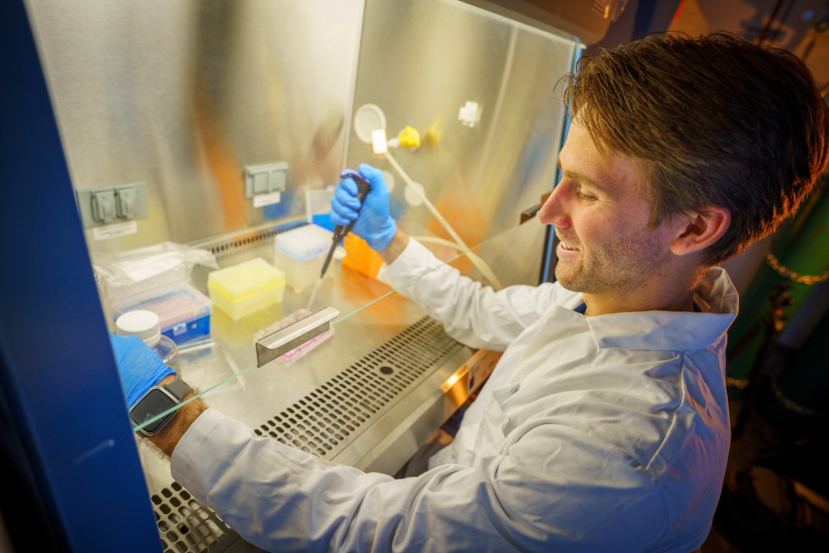 David McBride in the lab with a pipette