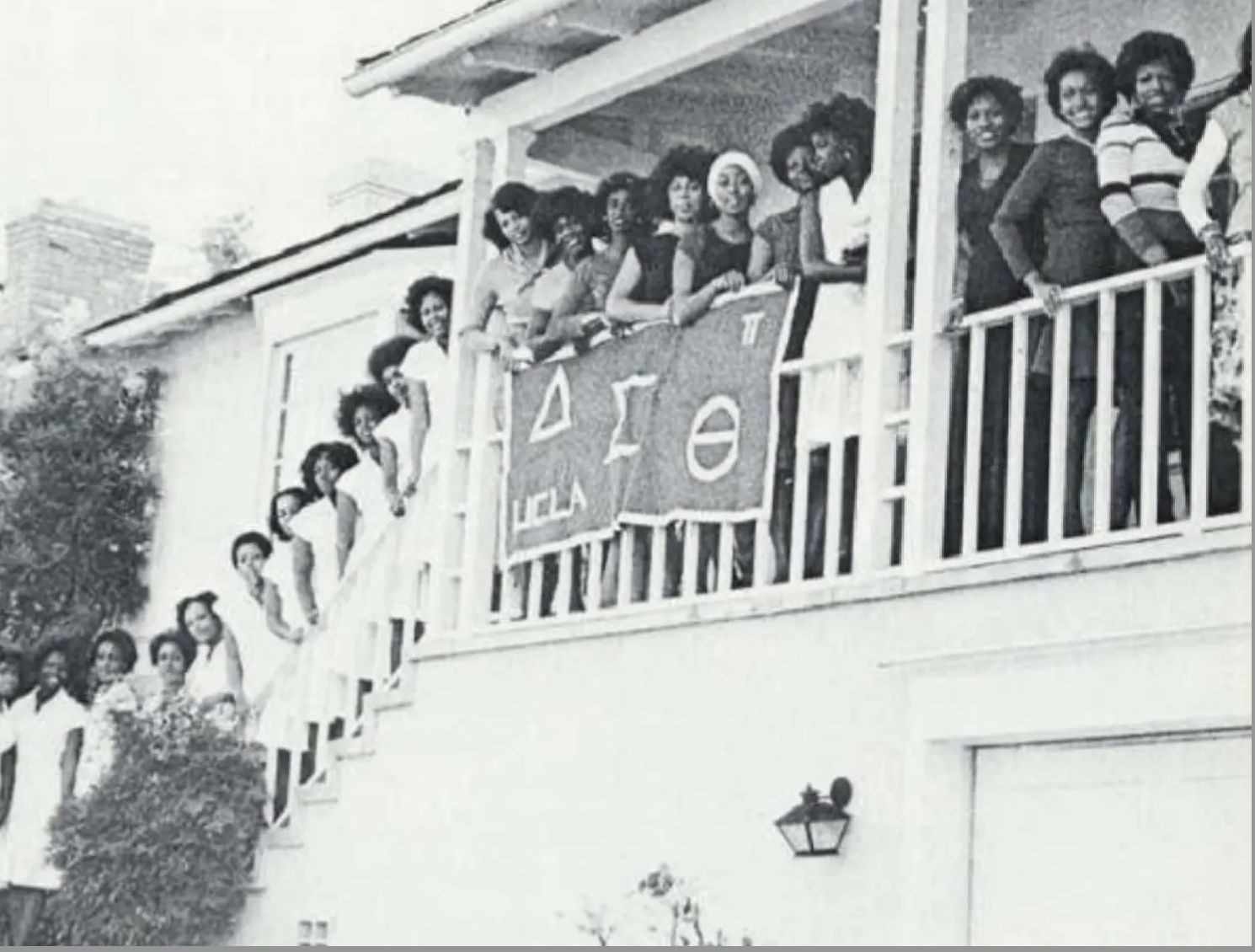 Members of the Pi chapter of Delta Sigma Theta standing on outdoor stairs and balcony the 1960s