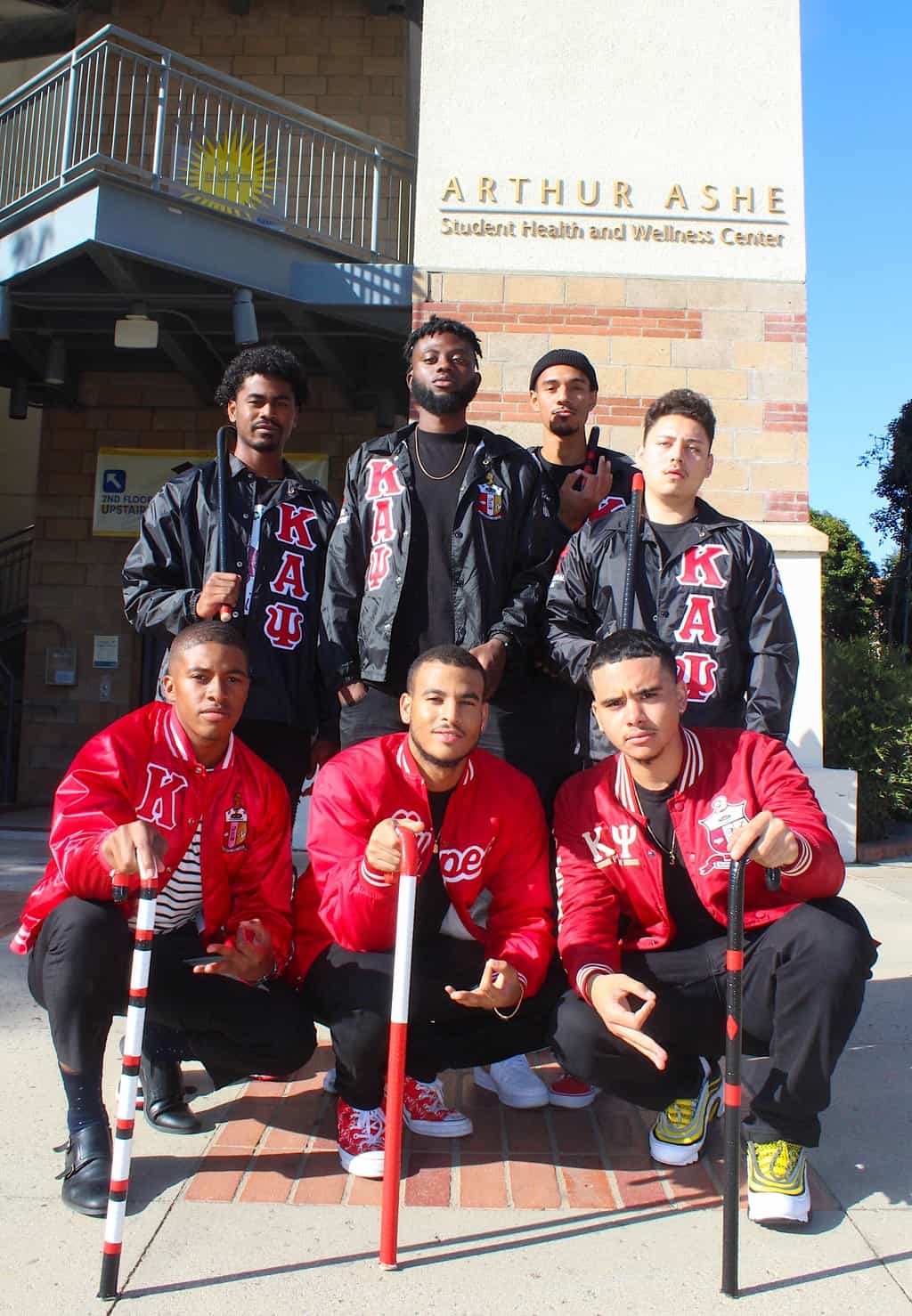 Members of Kappa Alpha Psi’s Upsilon chapter wearing fraternity jackets outside the Ashe Center on the UCLA campus