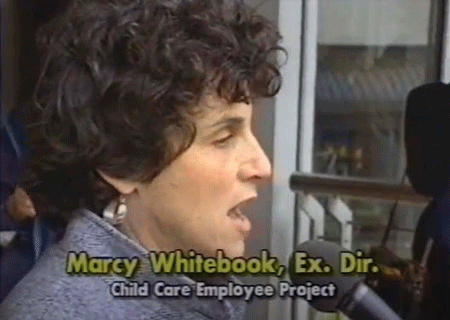 Marcy Whitebook speaking into a mic on an old TV screenshot