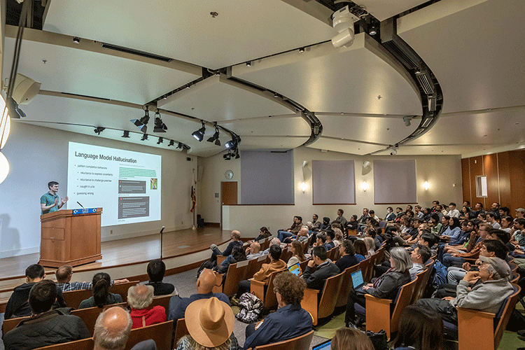 Schulman speaking to a lecture hall full of students