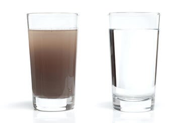 A glass of dirty water next to a glass of clear water