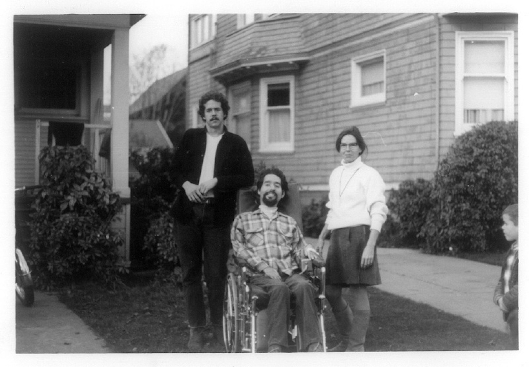 Zona, Ed, and his attendant, Bob Serrail outside a house in Berkeley