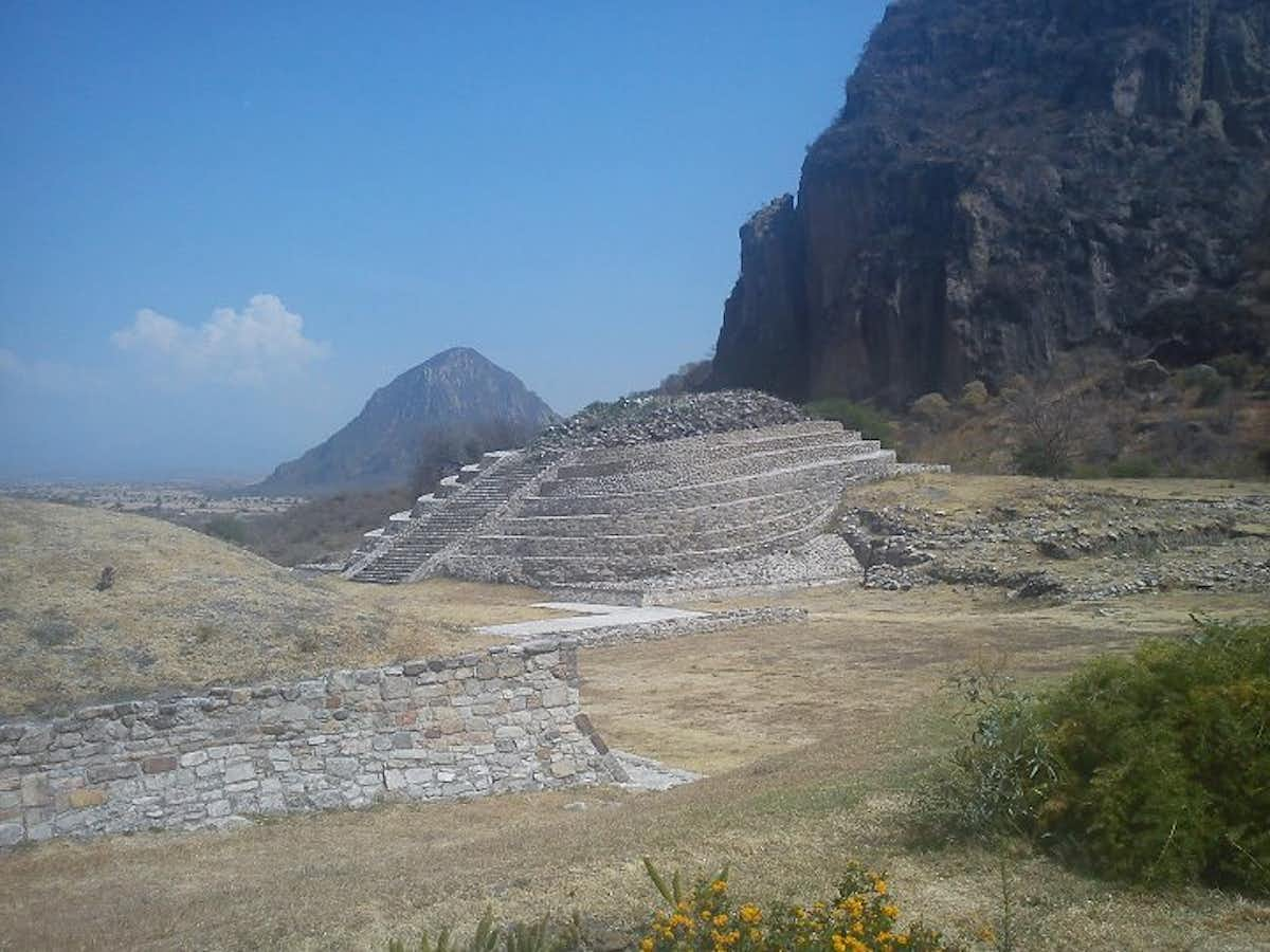 Olmec structure of ascending steps in a grassy canyon environment