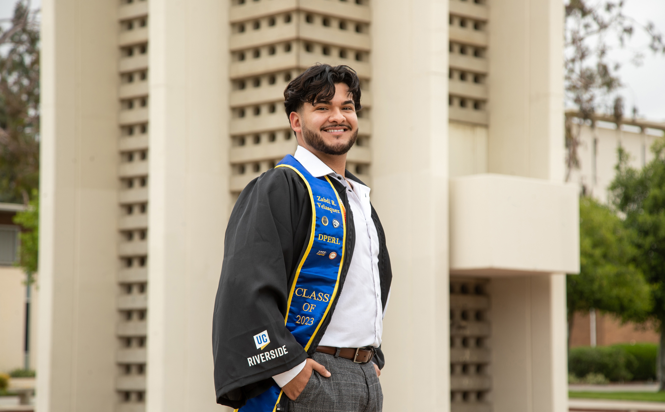 Zabdi Velásquez in graduation stole, smiling