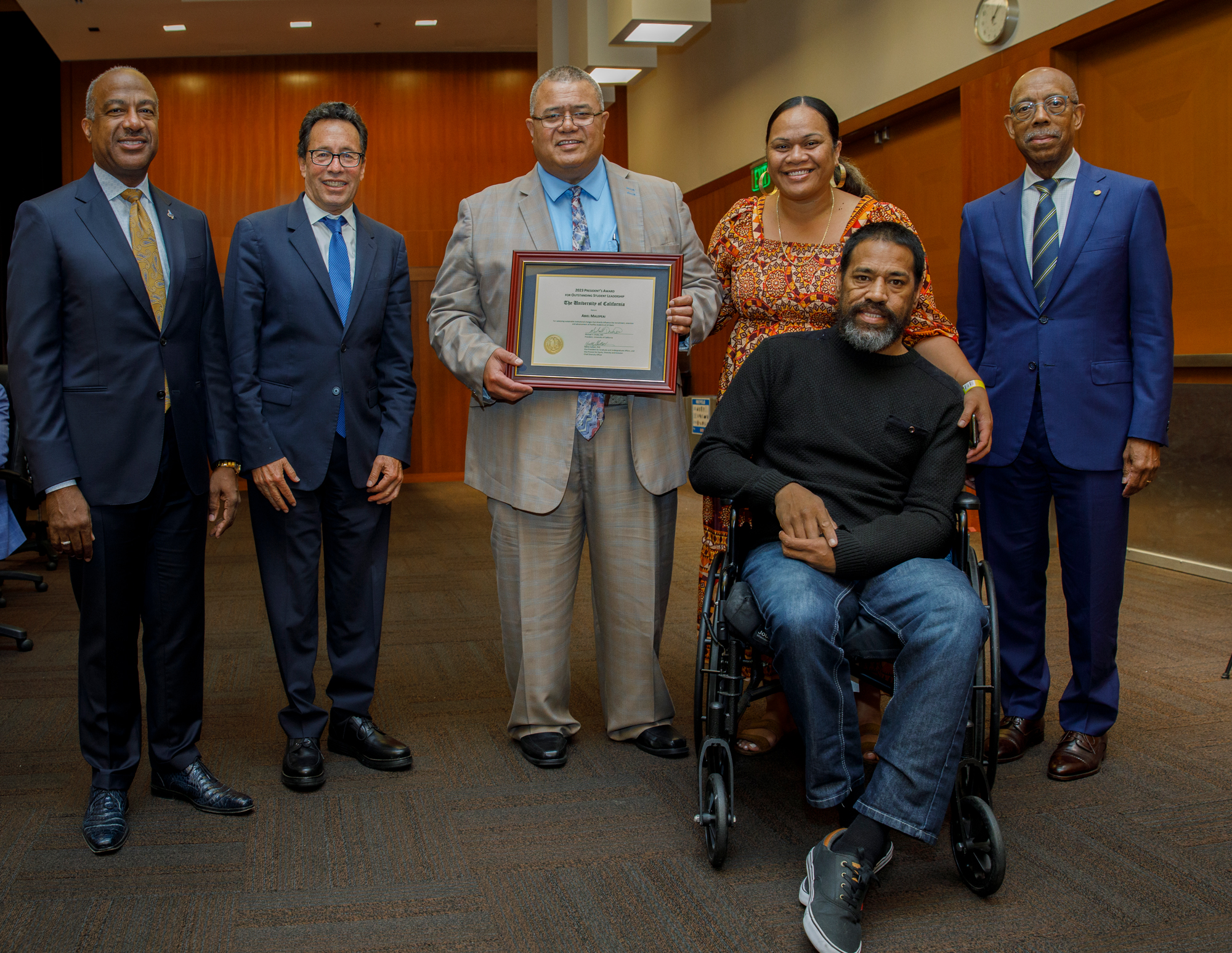 Chancellor May, Regent Leib, Abiel Malepeai's father, mother and other male family member, in wheelchair, and President Drake