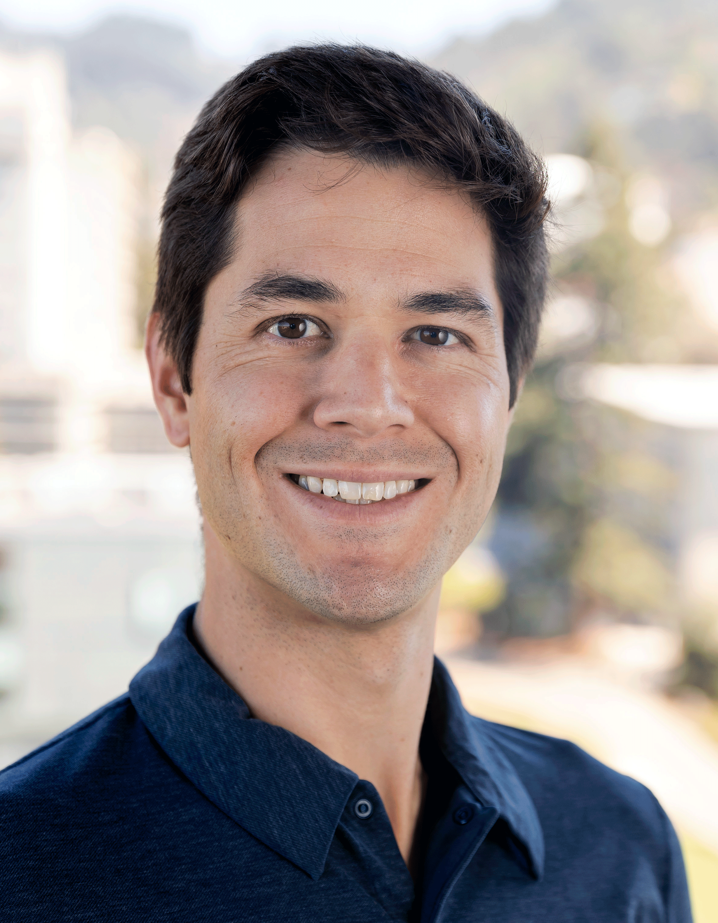 White man with dark hair smiling, Kirk Bansak