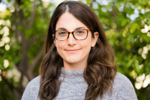 Portrait of white woman with glasses and long brown hair, Eli Michaels