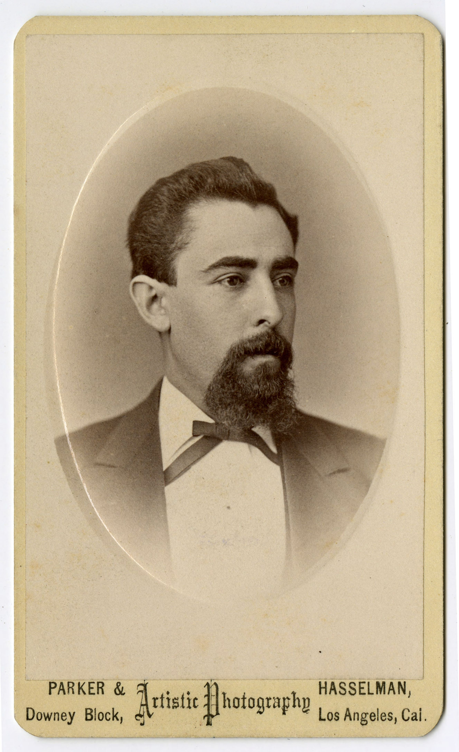 19th-century carte de visite showing a man with mustache and beard in a suit and string bow tie