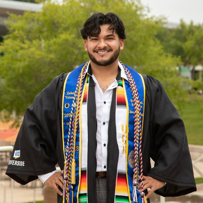 A smiling Zabdi Velásquez in graduation attire