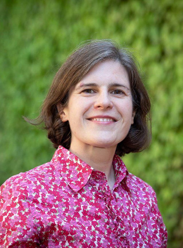 White woman with bob and fuchsia shirt