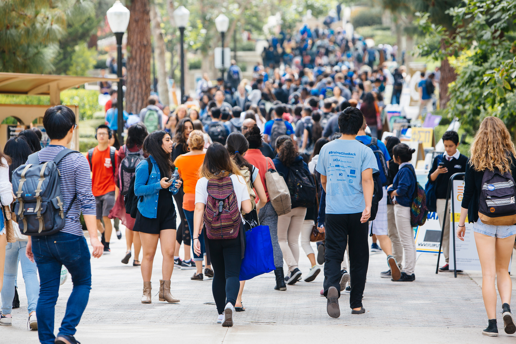 A large crowd of students walking on a walkway at UCLA