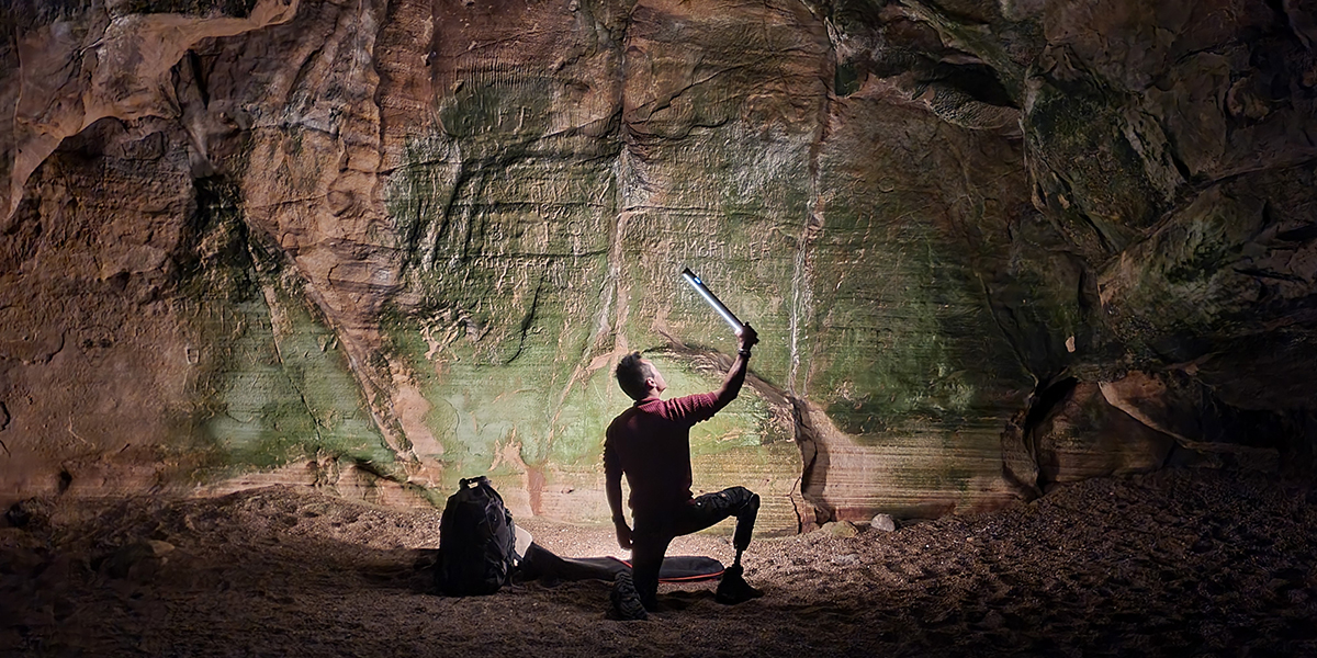 Albert Lin sheds a light on a cave wall